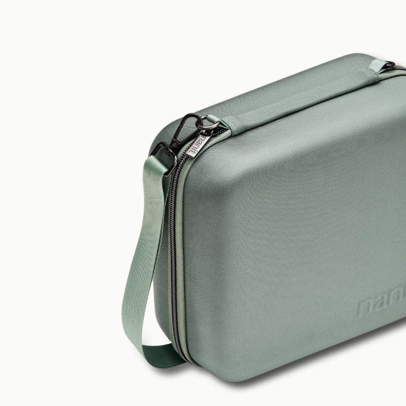 Angled shot of Nanit Traveling Light Case in green oxford