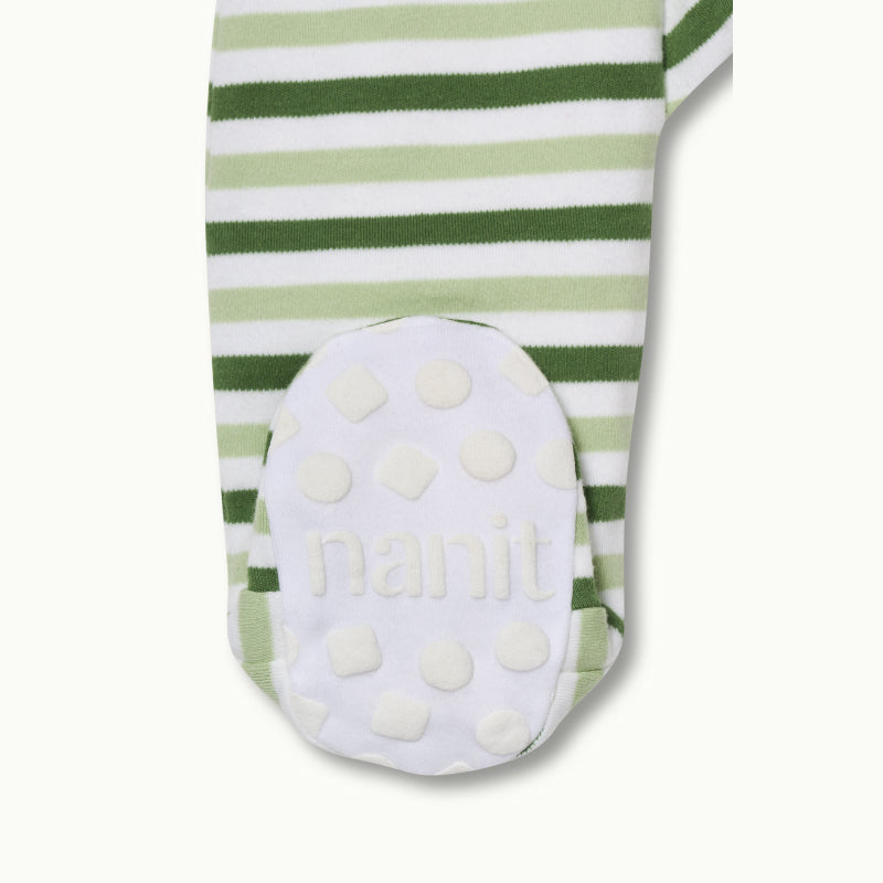 zoomed in on right feet in front view of sleep wear pajamas in evergreen bold stripe showing signature foot gripper