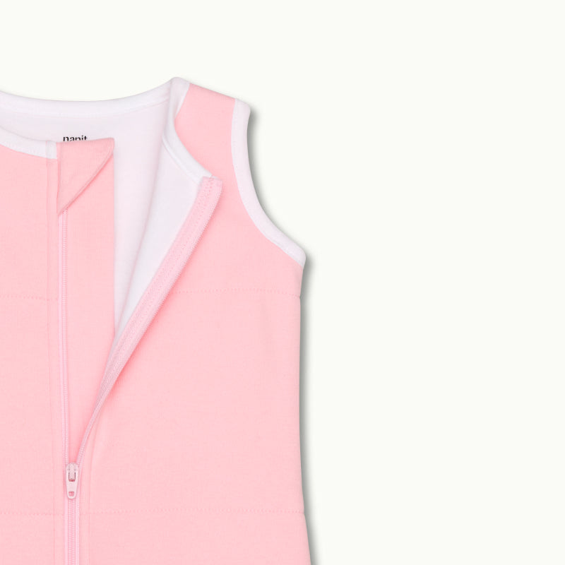 zoomed in on nickel-free snap tab zipper cover, plus protective chin zipper guard on sleeping bag in rose pink