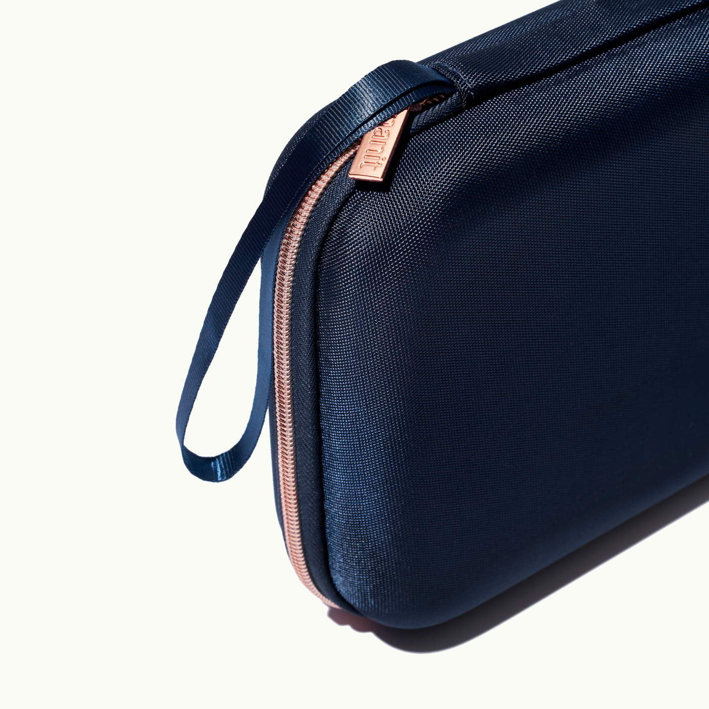 zoomed in picture of rose pink zipper and strap on blue travel case