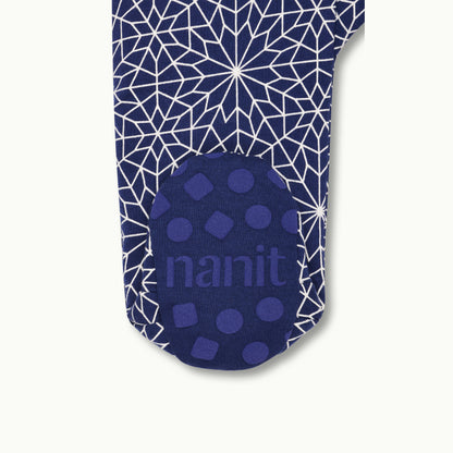 zoomed in on right feet in front view of sleep wear pajamas in bright star showing signature foot gripper 
