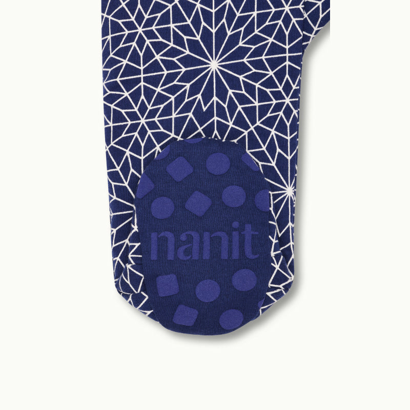 zoomed in on right feet in front view of sleep wear pajamas in bright star showing signature foot gripper 
