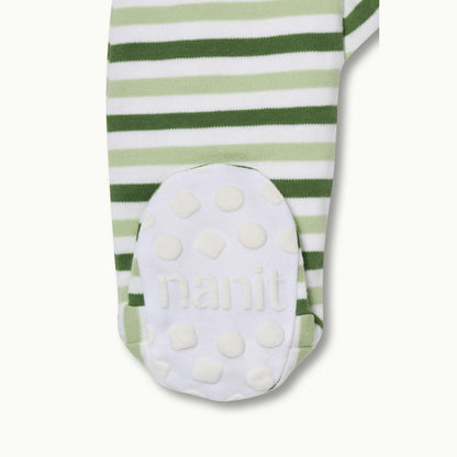 zoomed in on right feet in front view of sleep wear pajamas in evergreen bold stripe showing signature foot gripper 