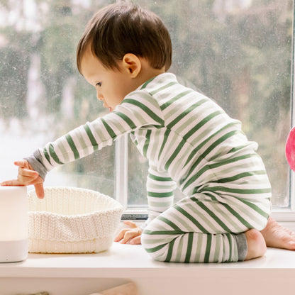 Toddler wearing Nanit Two-Piece Pajamas in Evergreen Bold Stripe